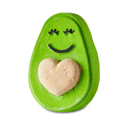 Avo Cuddle. A bright green, off-oval, avocado-shaped bubble bar complete with a heart-shaped stone and a smile. 