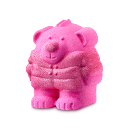 Rosy Bear. A bear-shaped bath bomb with a vibrant pink body, featuring a sculpted face and small fur details. The bear wears a chunky, double-breasted puffer jacket covered in a fine layer of silvery glitter.
