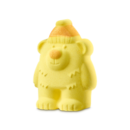 Honey Bear. A bear-shaped bath product with a bright yellow body, featuring a sculpted face, a round orange nose, and small fur details. The bear wears a ribbed beanie hat topped with an orange tip.
