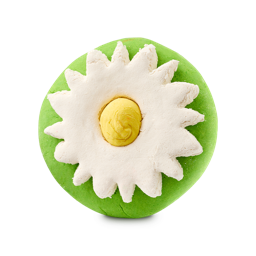 A round, bright green "Blooming Beautiful" bubble bar features a large, white flower design on top. The flower has textured petals and a yellow center, resembling a daisy, set against a plain light background.