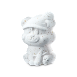 Butterbear. A bear-shaped bath bomb. The white, textured figure features a smiling face and a festive Santa hat, speckled throughout with fine brown flecks of solid butters.