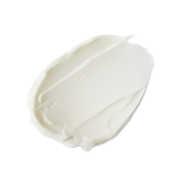 A studio shot of a textured swatch of LUSH Celebrate body lotion, a thick and creamy white product, against a light gray background.