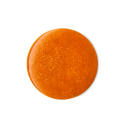 Cinnamon Spiced Latte. A perfectly circular swatch of thick, glossy, bronze-coloured shower gel with golden flecks of glitter throughout. 