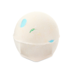Dragon's Egg. A spherical, pale off-white bath bomb with a flat, geometric base. It has small, colourful spots of blue and green peeking through the surface.