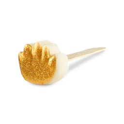 A white solid hand mask on a flat wooden stick, shaped like a hand print and covered in a textured coating of shimmering gold glitter