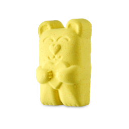 Mamma Bear. A bright yellow, almost-gummy bear-shaped bath bomb complete with a heart-shaped nose and paws holding a heart in front of its chest. There are tiny flecks of pink throughout.