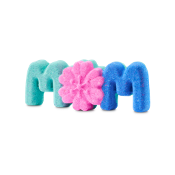The "Mum" bath bomb is shaped to spell the word "MOM" in three connected parts. The first "M" is teal, the center "O" is a pink flower with textured petals, and the final "M" is a vibrant blue.