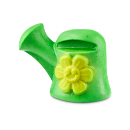 A bright green soap shaped like a watering can features a yellow flower with a smiley face on the front, set against a plain background.