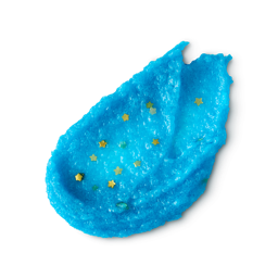 A studio shot of a textured swatch of LUSH Shoot for the Stars body scrub, a chunky, bright blue scrub with small, yellow, star-shaped glitters, is shown against a light gray background.