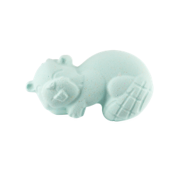 The image shows a speckled, pale teal bath bomb shaped like a cartoon beaver lying on its side. It features an embossed, toothy smiling face and a cross-cross pattern on its tail.