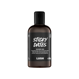 A clear bottle filled with rich, dark brown Lush Sticky Dates shower gel, topped with a black cap and featuring a black label