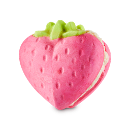 Strawberry Crumble Bubbleroon. A heart-shaped strawberry bubble bar featuring two pink strawberry halves with textured "seeds" and a green leafy top, sandwiched together with a thick layer of white cream.
