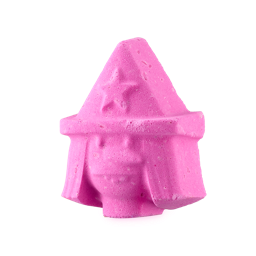 Witch - Monster Mash Head. A playful, bright pink bath bomb shaped like the head of a witch, complete with straight hair, a large nose and a pointed hat with a star on.