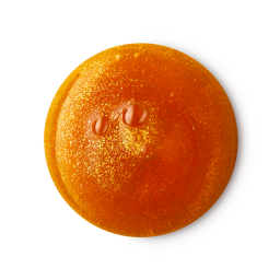 Yog Nog shower gel. A perfectly circular swatch of deep, golden shower gel with sparkling glitter throughout. 
