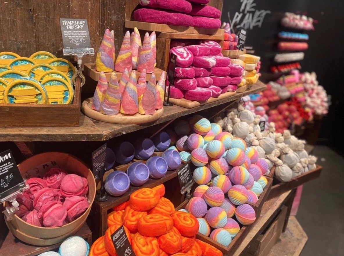 Interior view of shop. Large display of various brightly coloured unpackaged bath products.