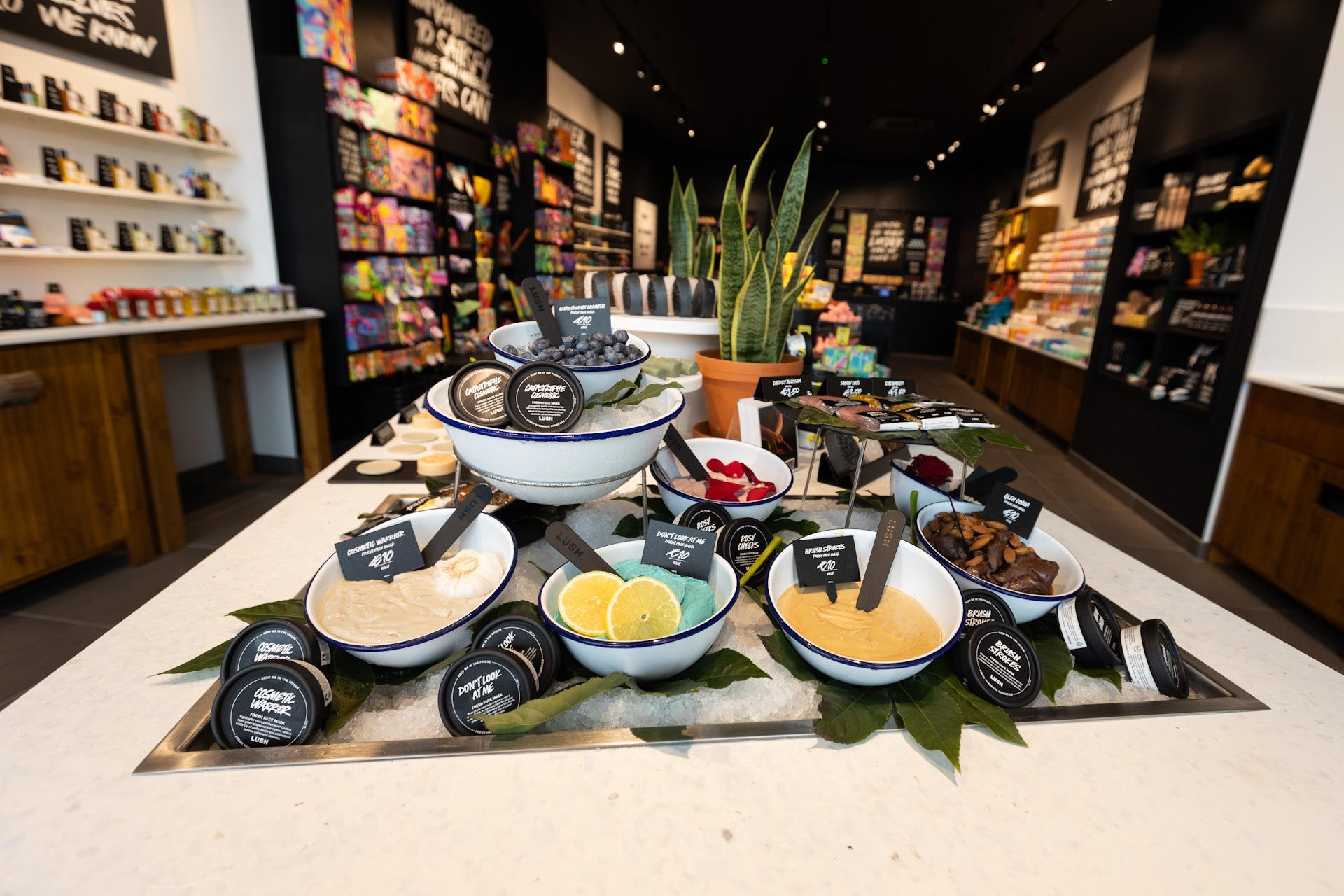 Interior of shop. Large white display unit filled with ice. Bowls and pots of fresh face masks are nestled in the ice. Further product displays visible in background.