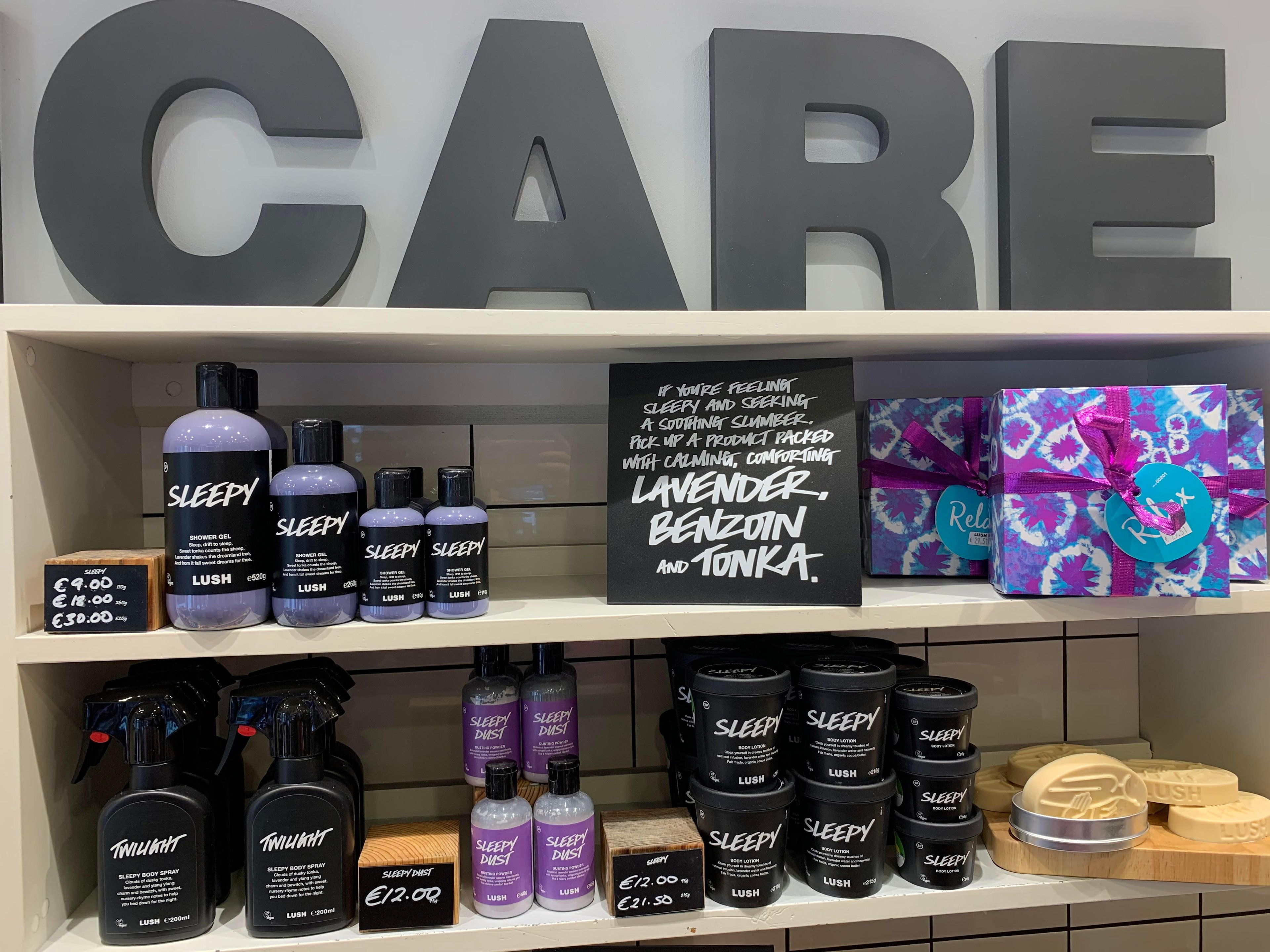 Packaged and unpackaged products on shelves below a large sign spelling Care.