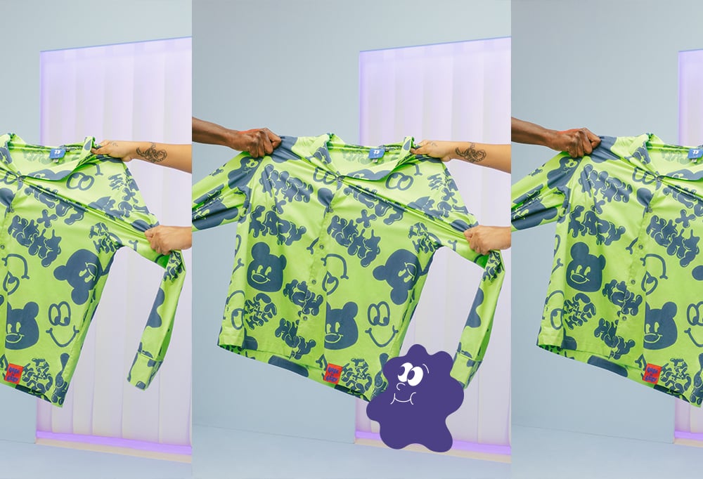 A Light bright green pyjama shirt with dark navy blue Lazy Oaf smiley designs on it, displayed by models holding it up.