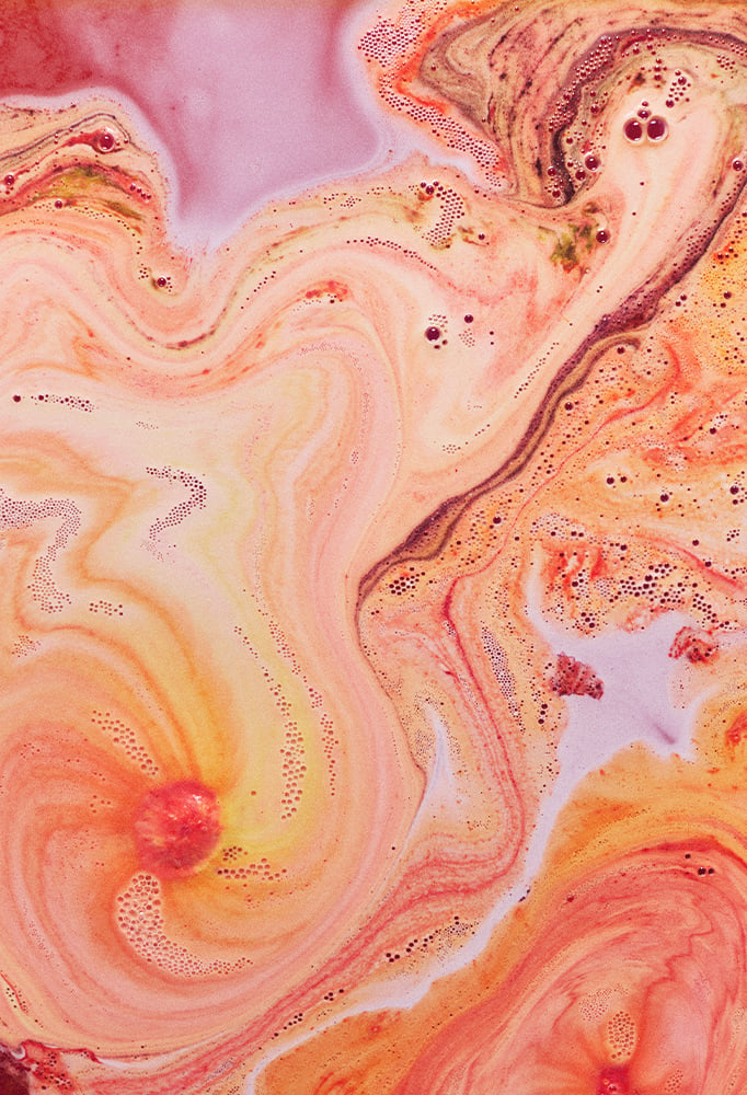 The Rift bath bomb fizzes and crackles away, leaving fiery orange and red foam swirls, over deep red waters.