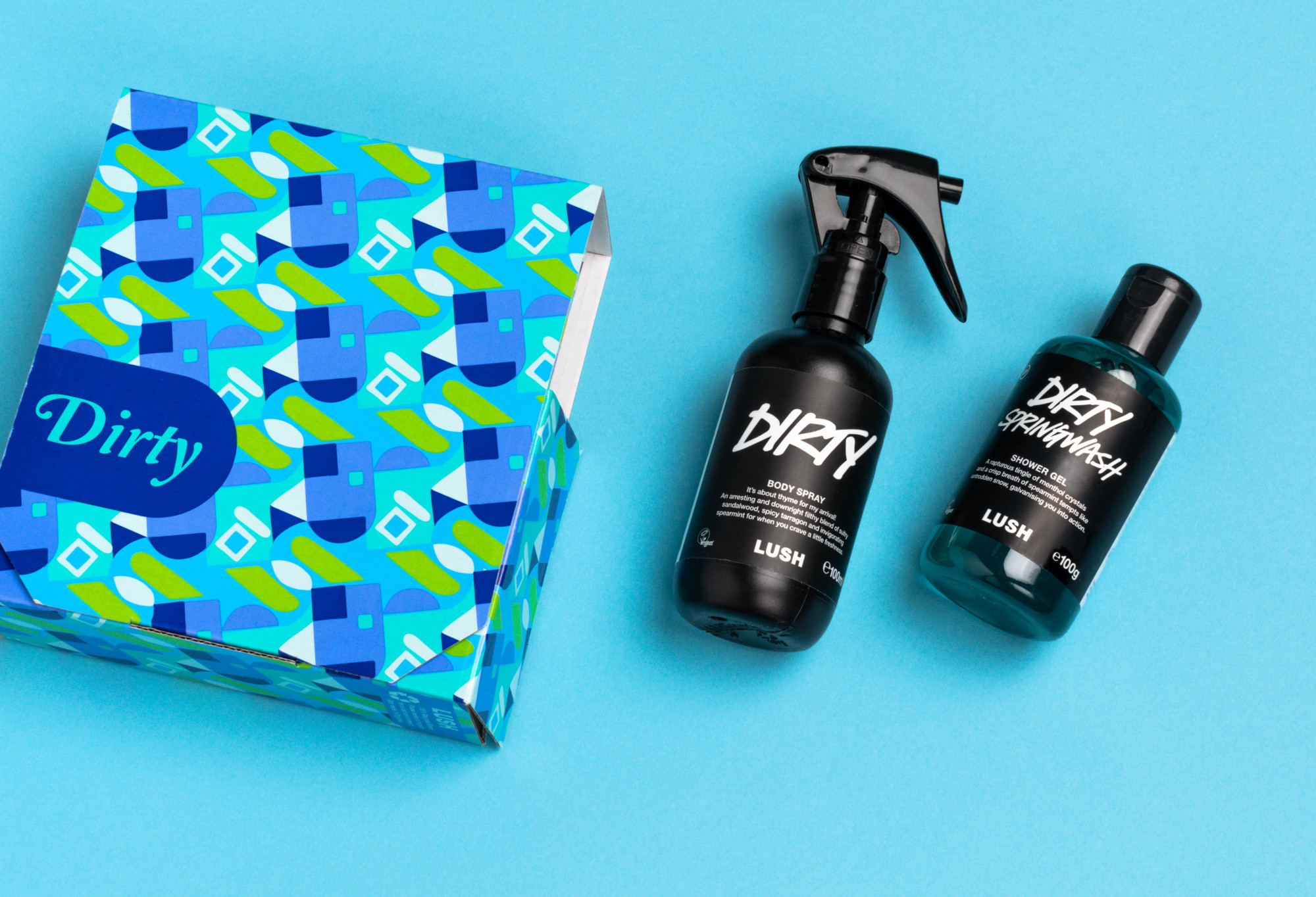 Dirty (the gift) box and its contents (100ml Body Spray and 100g Shower Gel) are displayed on a light blue background.