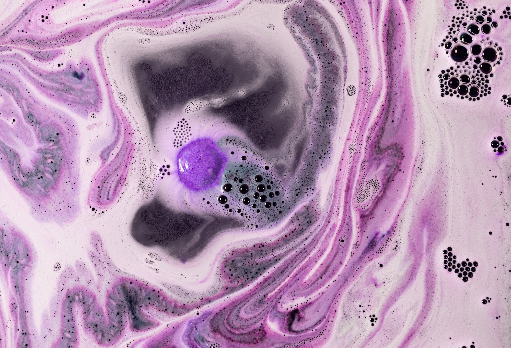 Gum-Gum Fruit bath bomb swirls and fizzes in magically deep and bright purple waters.