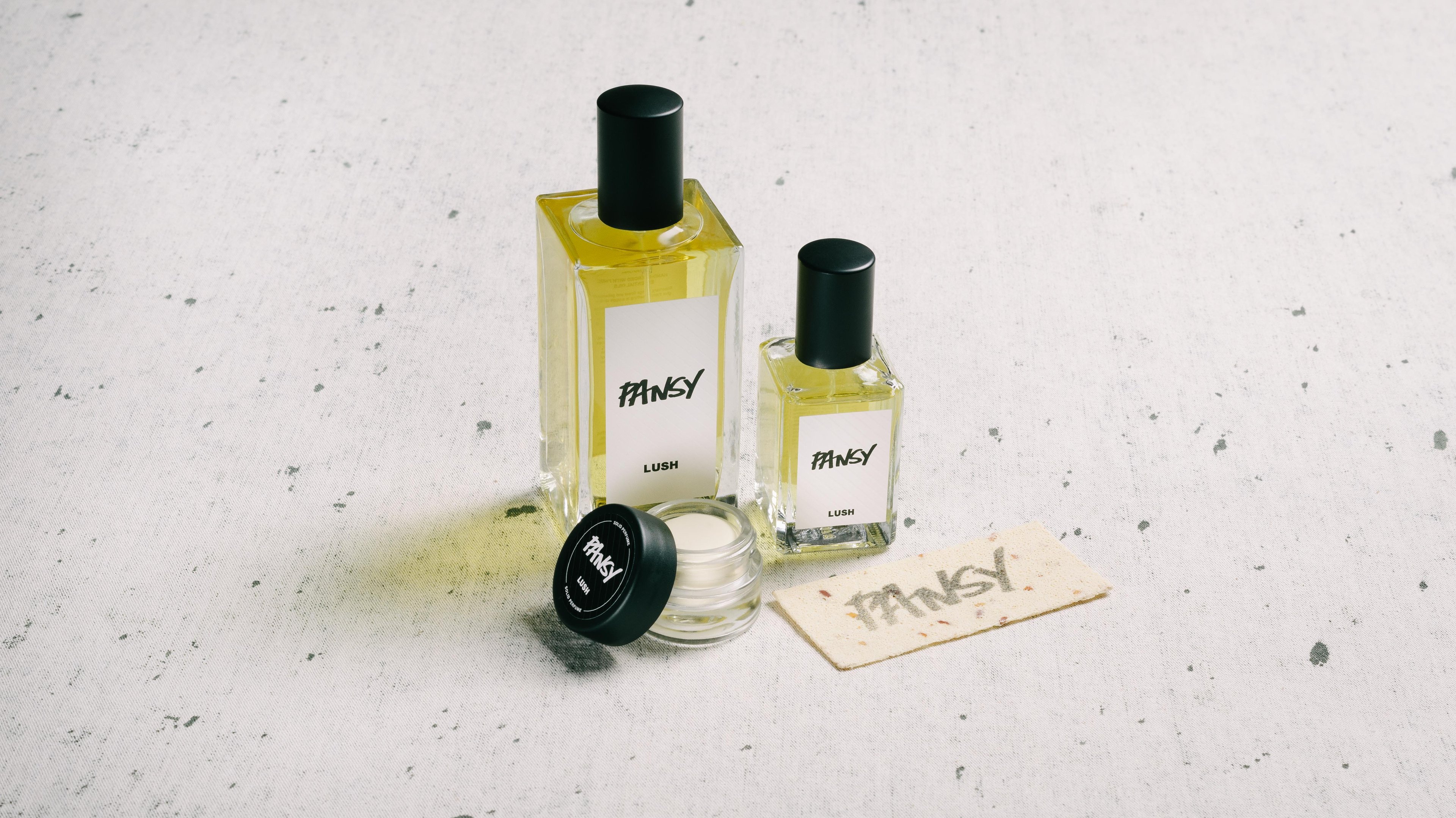 The whole Pansy fragrance collection is displayed on a white surface, flecked with grey.
