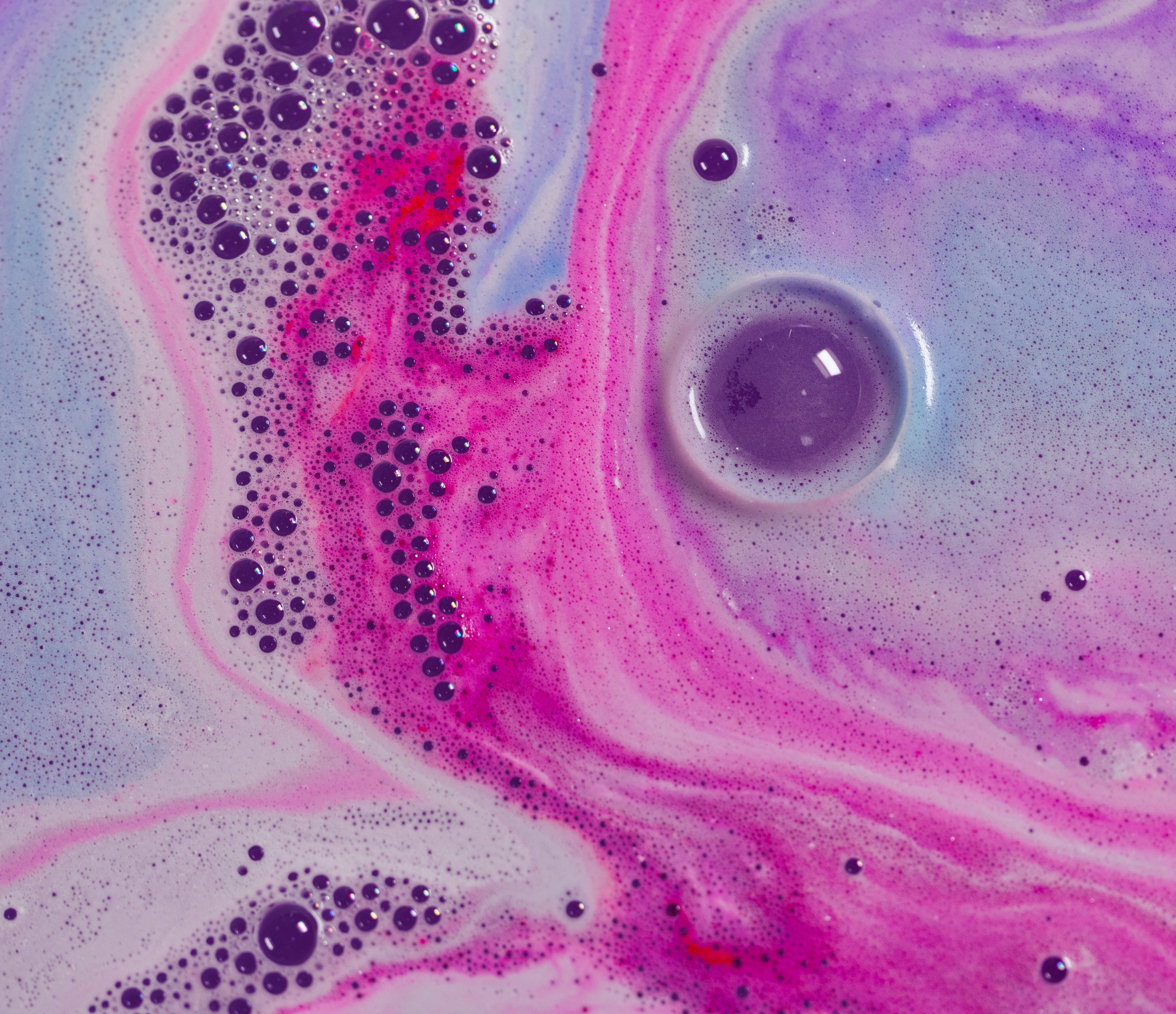 A close-up of colourful swirls of magical pink, blue and purple.