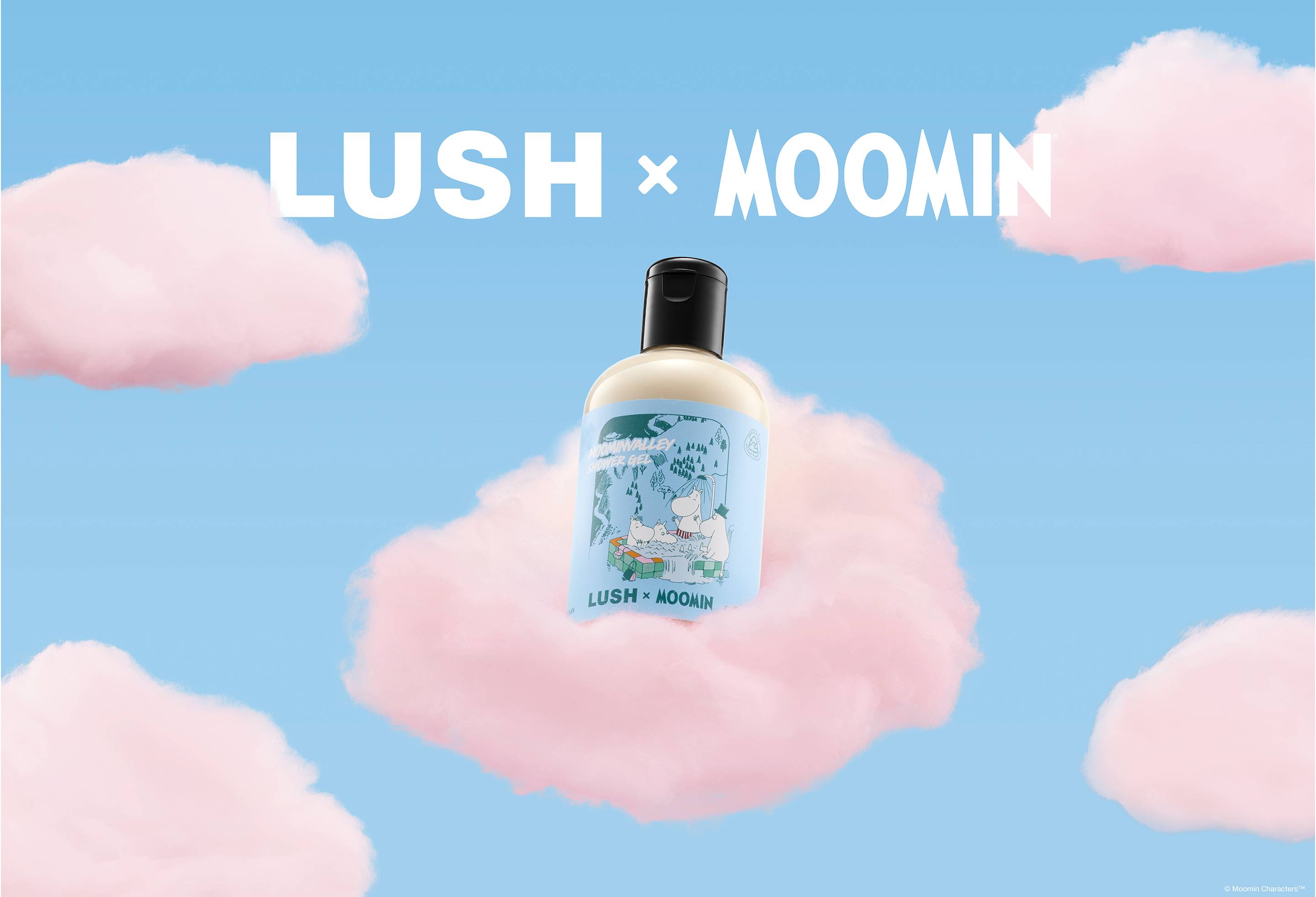 A bottle of Lush x Moomin Moominvalley shower gel resting on a fluffy pink cloud against a pastel blue sky with pink clouds, below white text that reads 'LUSH x MOOMIN'.
