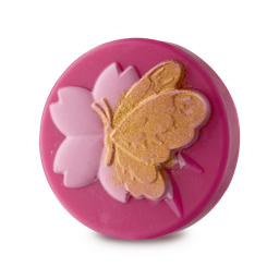 17 Cherry Tree Lane. A hot-pink, circular soap slice. Embossed on the top is a pastel-pink Sakura flower and a butterfly covered in golden lustre. 