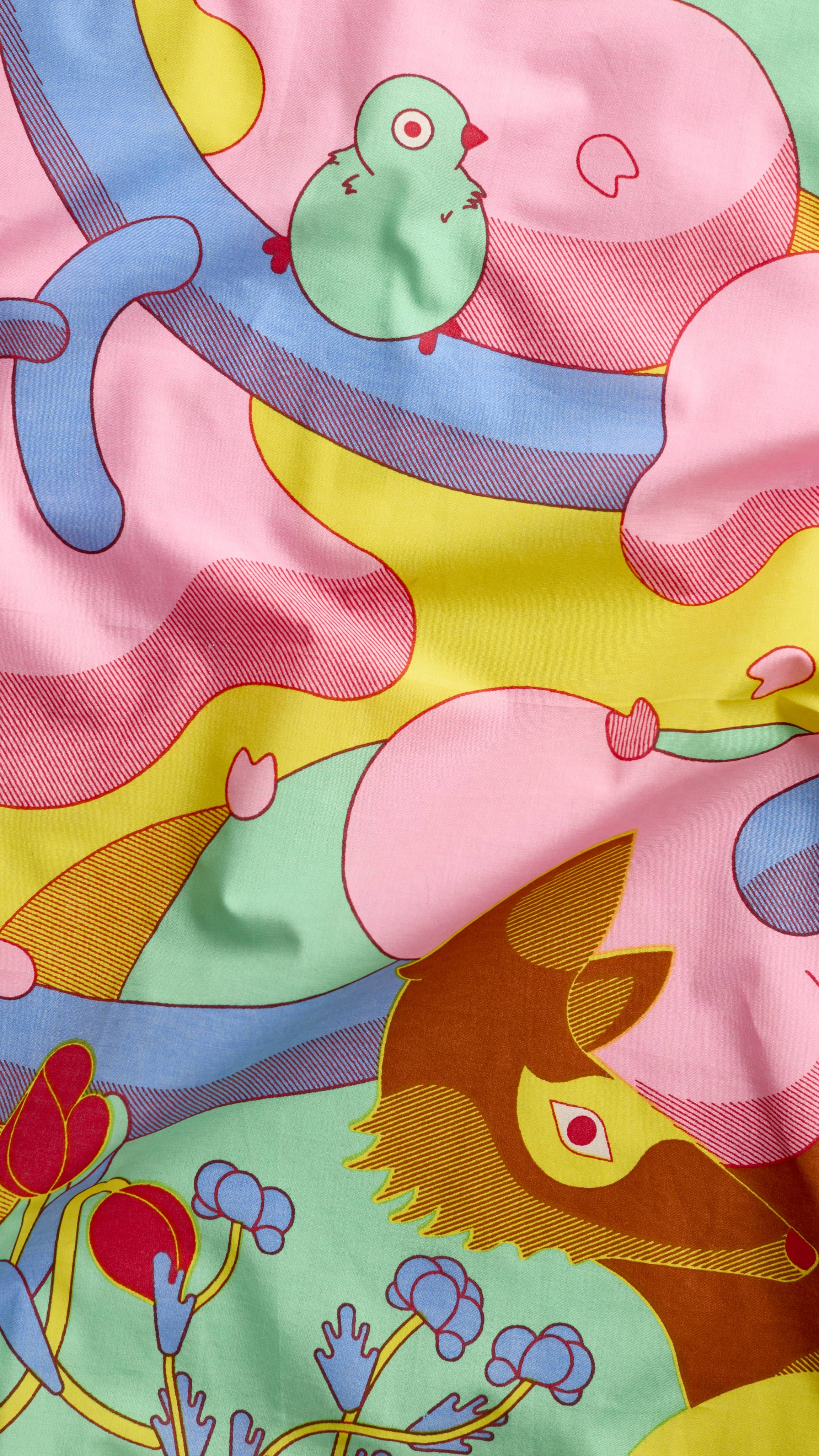 A super close-up image of the "Forest Awaken" fabric knot wrap. The shot focuses on the vibrant colours of the design and the soft fabric texture.