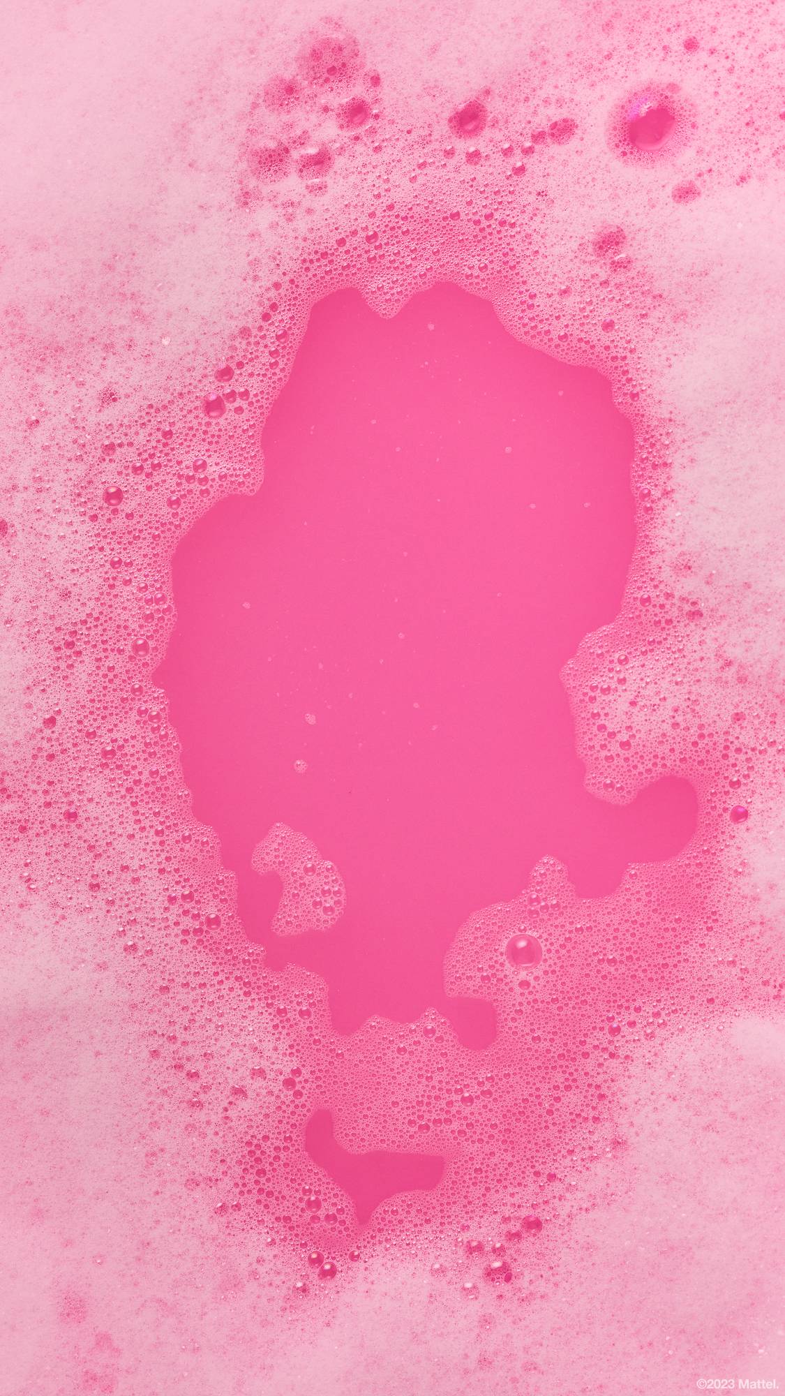 Image shows a close-up of deep, hot pink bath water framed by thick pink bubbles.