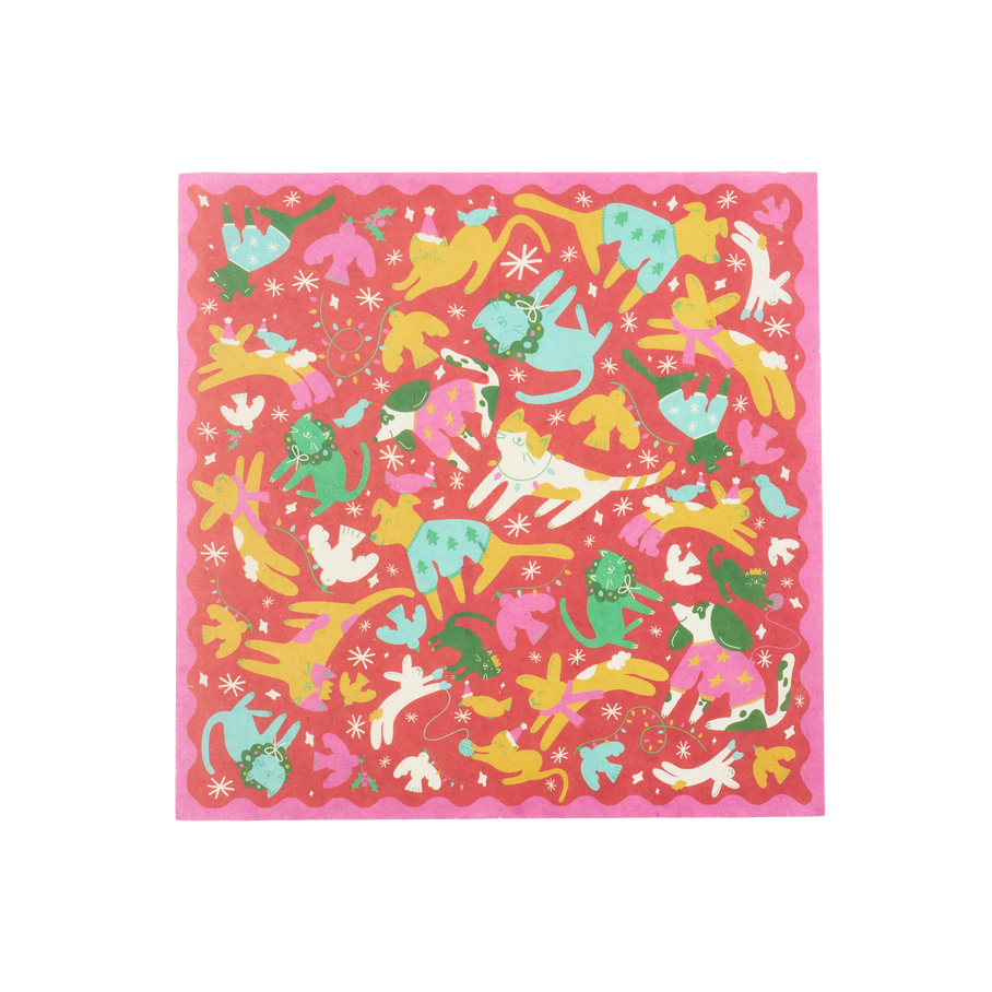 Christmas Companions. A square sheet of Lokta wrapping paper. It features a pink, scalloped border, red background and illustrations of colourful dogs, cats, rabbits and birds with snowflakes, Santa hats and fairy lights. 