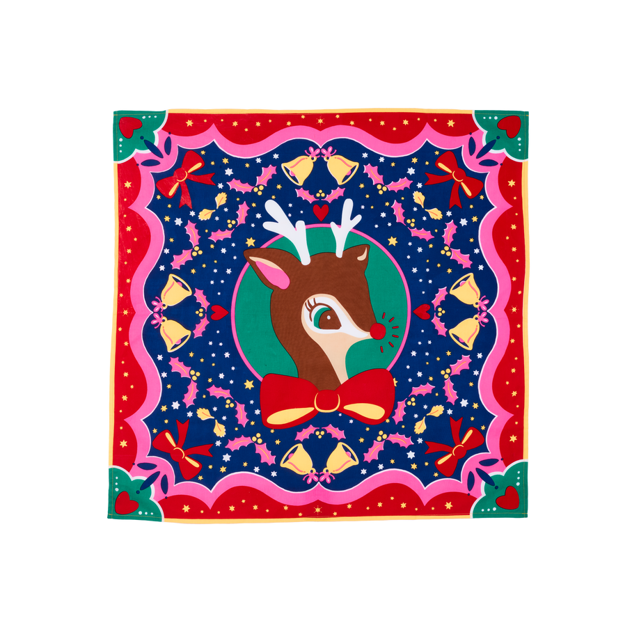 It's Christmas Deer. A square, fabric knot wrap with a vibrant, festive design of a reindeer in the center. The wrap features a border of bells, ribbons, and stars on a dark blue background.
