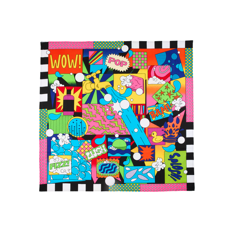 Lush Pop Art. A square, fabric knot wrap with a colourful pop art design in black, blue, pink, red, and yellow, with text reading "WOW!", "POP!", "BAM!", "FIZZ!", and "SPLOSH!". A stylised gold faucet is at the centre of the design.