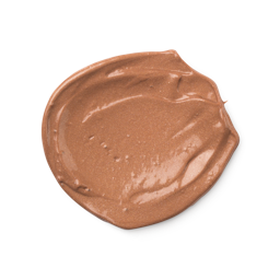 A close-up product swatch of a thick, rounded, creamy dollop of Charisma Skin tint. The product has a shimmery, bronze-brown color with a metallic finish