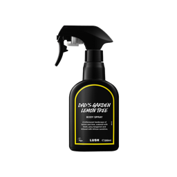 Dad's Garden Lemon Tree body spray. A black spray bottle of Lush "Dad's Garden Lemon Tree" Body Spray. The product label is black with a vibrant, dandelion-yellow banded border. White text states the product name and the scent description.