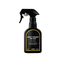 Honey I Washed The Kids body spray. A black spray bottle of Lush "Honey I Washed The Kids" Body Spray. The product label is black with a bright yellow banded border. White text states the product name and the scent description.