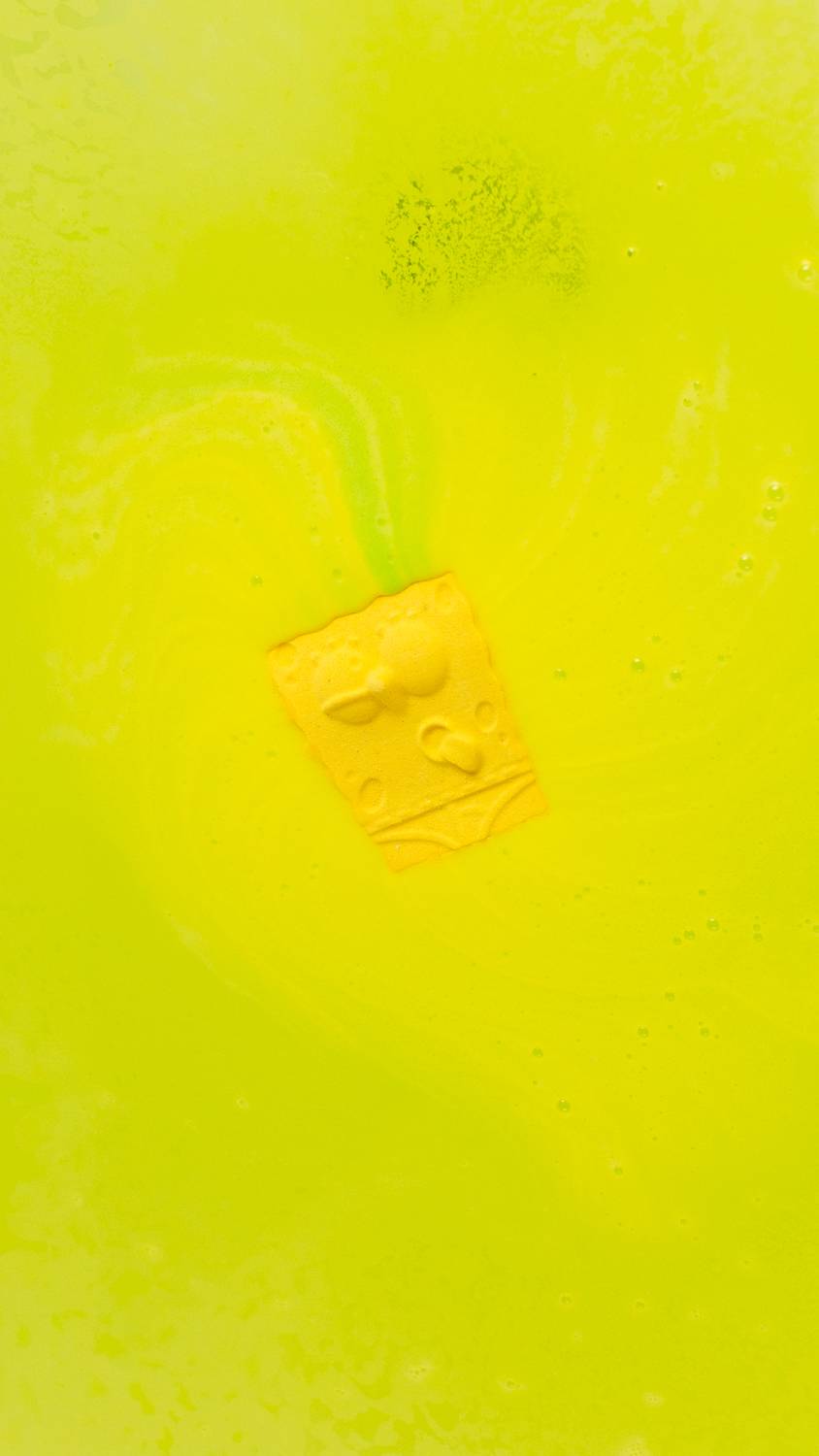 The Spongebob Bath Bomb fizzes among a luminous sea of yellow effervescent foam.