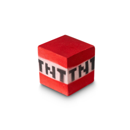 TNT Block. A perfectly cube-shaped bath bomb. There is a red top and bottom with a single white middle band around four sides and the letters "TNT" on each side.