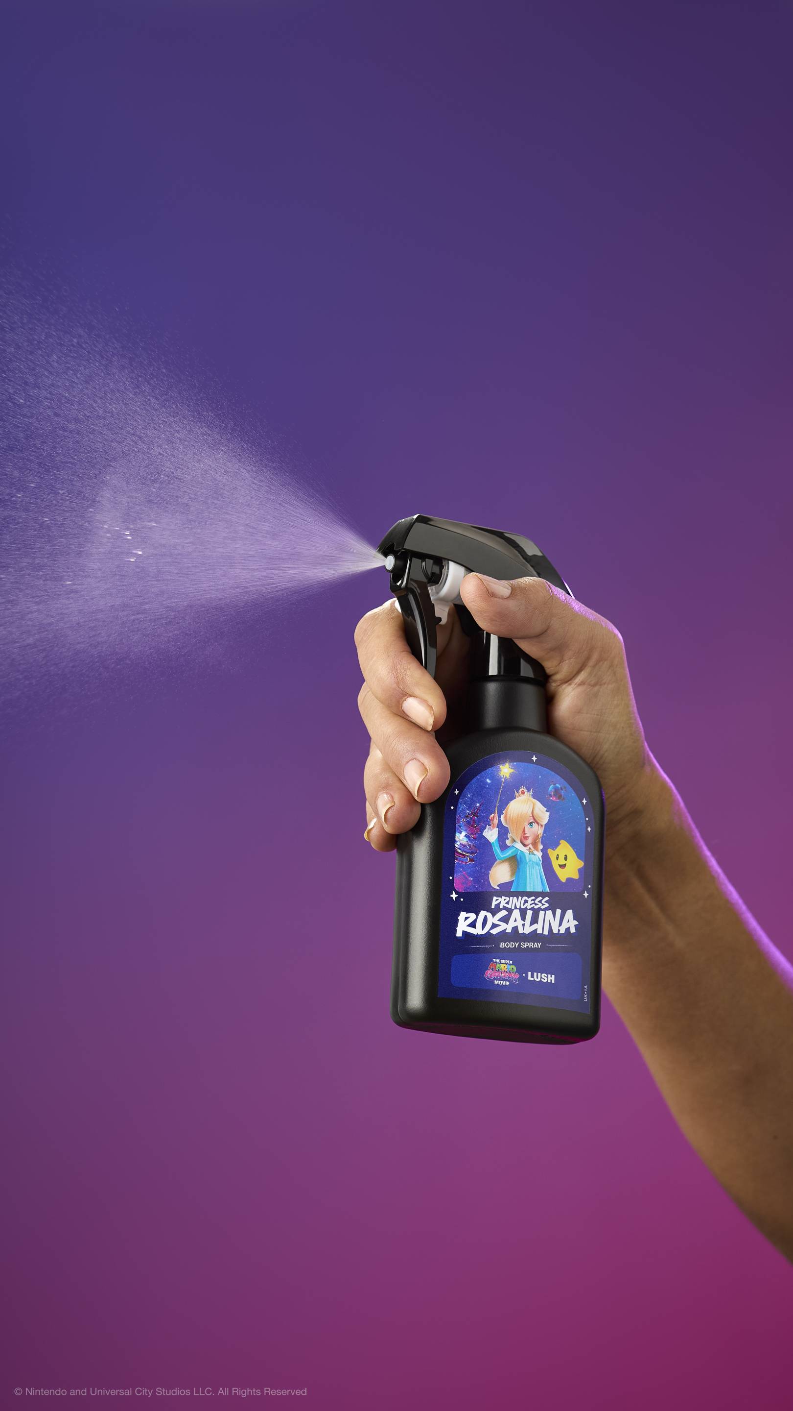 Hand sprays black Princess Rosalina body spray bottle against a purple-magenta gradient. Label features Princess Rosalina and a Luma. Movie and LUSH logos visible at the top.