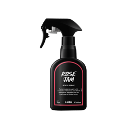 Rose Jam body spray. A black spray bottle of Lush "Rose Jam" Body Spray. The product label is black with a rose-pink banded border. White text states the product name and the scent description.