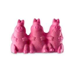 The Naughty Pigs. A novelty, bright pink shower jelly shaped like three cheerful pigs, complete with trotters and round snouts, sitting side by side. There are subtle, textured flecks of dark spots throughout the product for exfoliation.