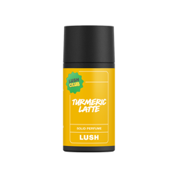 Turmeric Latte. A short, cylindrical black push-up tube of the "Turmeric Latte" solid perfume with a vibrant yellow label on the front, with the product name and scent printed on it. 