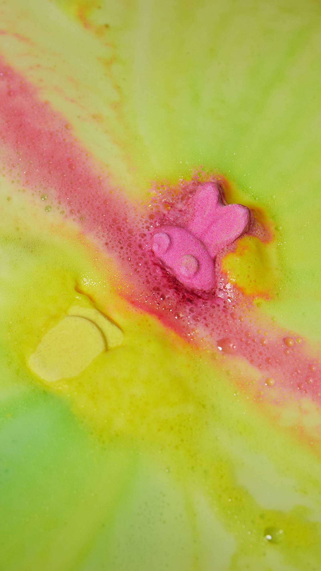 Alien Bunny Spaceship is slowly fizzing away in the bath water shooting off foamy swirls of bright yellow and pink.