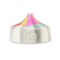 All The Fun Of The Fair. A fun bath bomb shaped like a classic fairground/circus tent. It is a white bath bomb with the number "30" embossed on the front. The top has marbled colours of pink, blue, yellow and orange. 