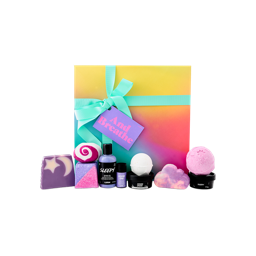 The And Breathe gift set features a sunset-gradient box with a mint green ribbon. In front are ten relaxing Lush products, including Sleepy shower gel, bath bombs, and soaps.