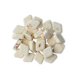 A pile of small, diamond-shaped Banana Bread mouthwash tabs. The tabs are an off-white color with dark brown specks, resembling the texture of banana bread
