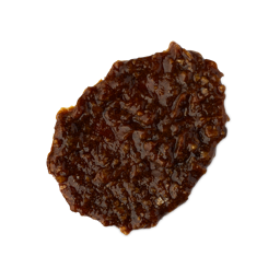 Banana. A smudged swatch of thick, textured shampoo. It is a rich hazelnut-brown colour with an almost treacle-like consistency and a lot of texture. 