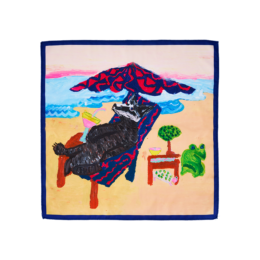 Beach Badger. A square, fabric knot wrap featuring a badger relaxing on a sun lounger under a patterned umbrella at the beach. The playful scene includes a cocktail, a green frog, and a small turtle, all set against a sandy shore and blue ocean.