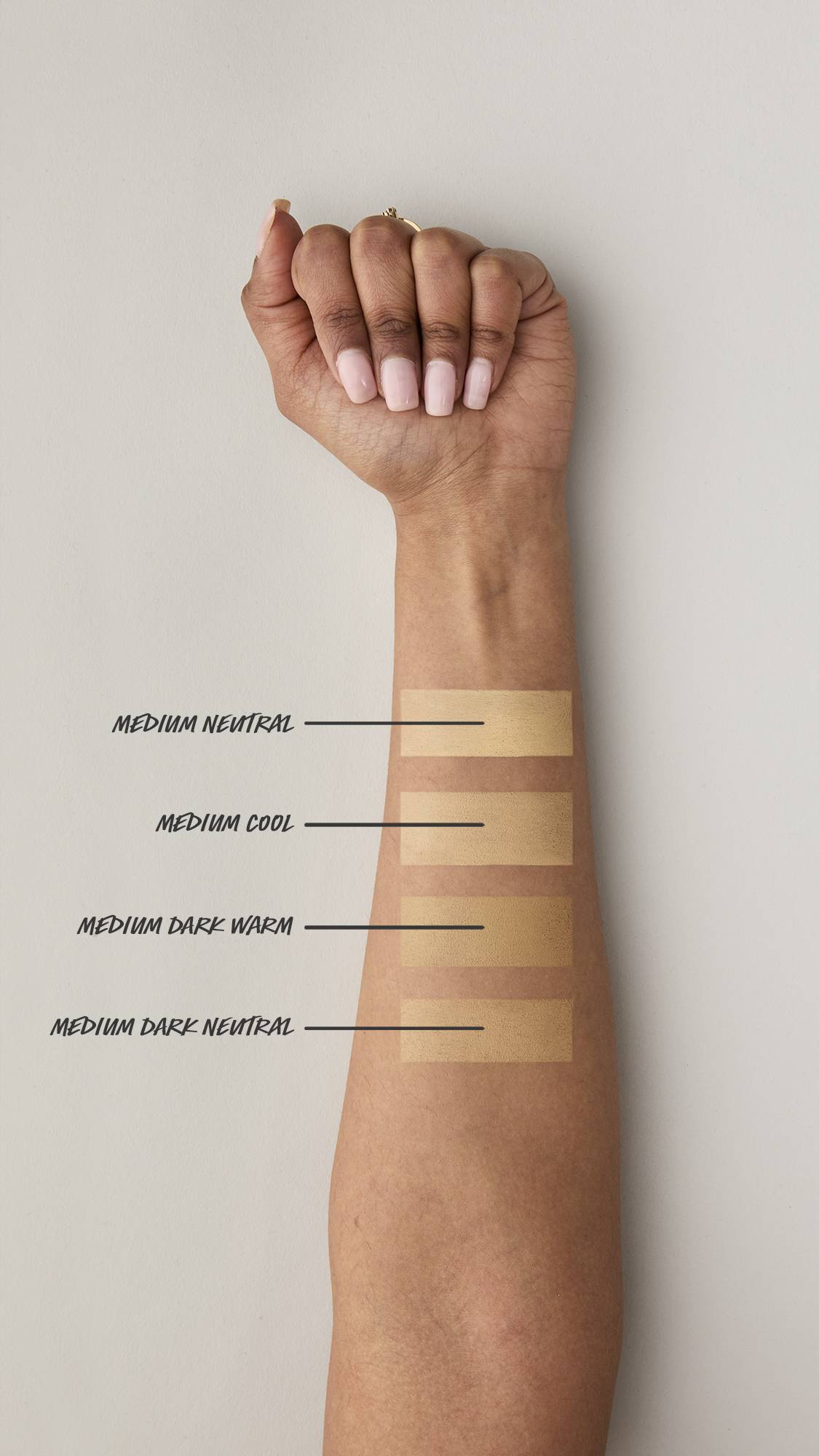 Four swatches of beauty balm are applied to the underside of a medium-skinned forearm. Shades are listed from top to bottom: Medium Neutral, Medium Cool, Medium Dark Warm, and Medium Dark Neutral, showing the shades against the medium skin tone.